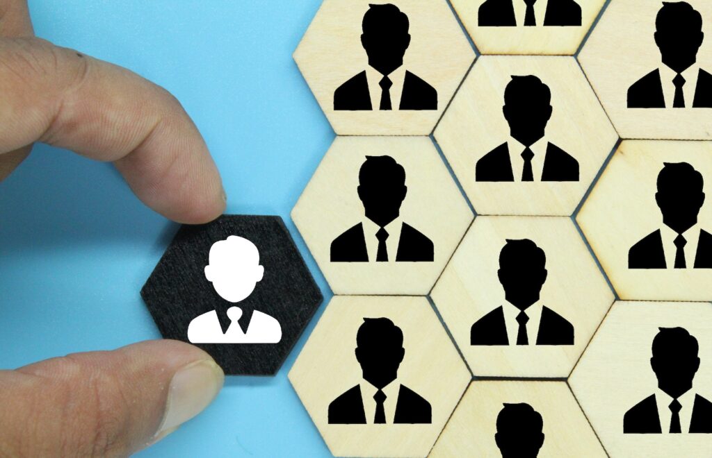 hexagon with an old employee icon and a new employee. the concept of workers or HR